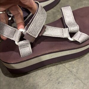 Women’s purple and silver Teva’s